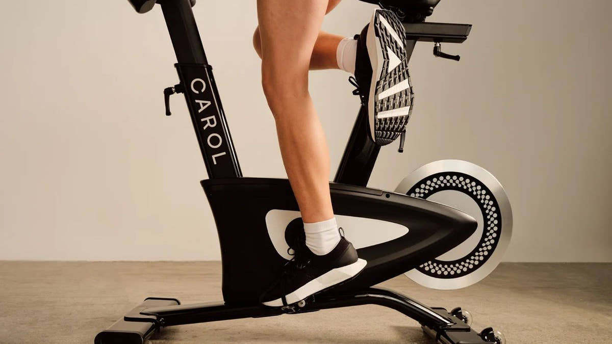 Rider's foot driving the pedal on a CAROL Bike in warm light