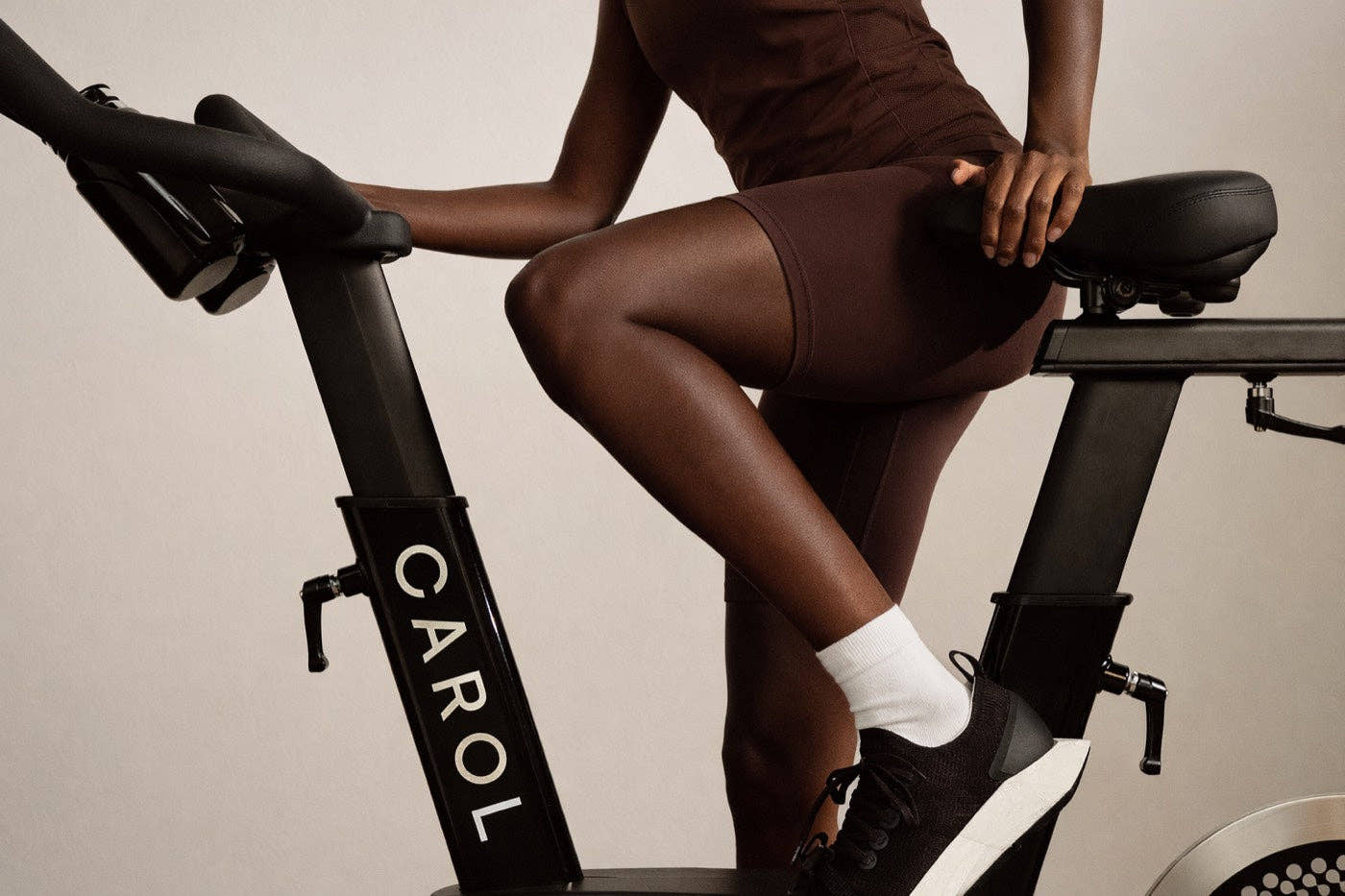 Close view of a rider's legs turning the pedals, CAROL Bike frame in profile