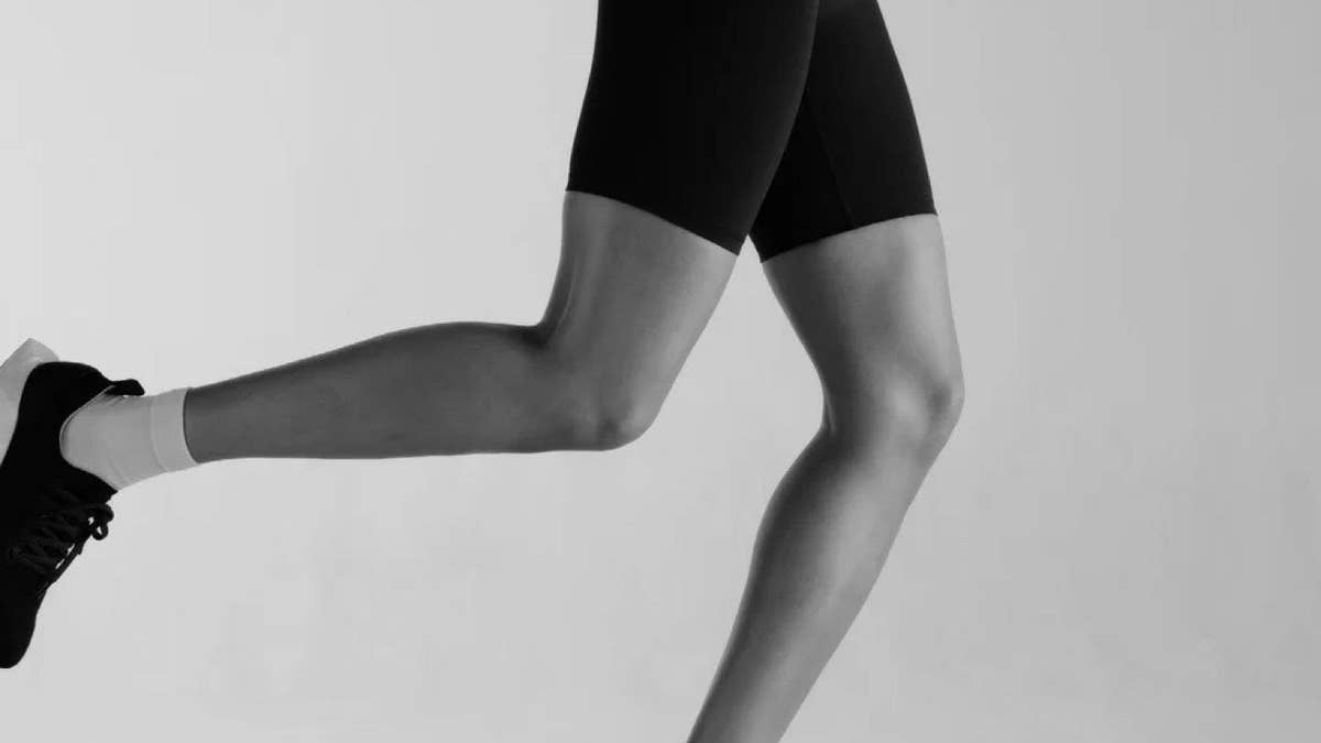 Black and white photograph of a runner mid-stride
